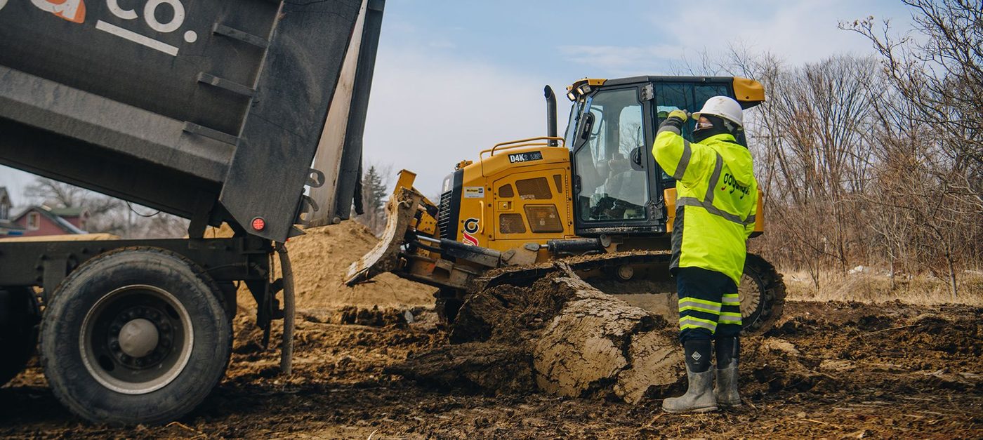 Gayanga dump truck and dozer spreading fill on a cleared Detroit lot